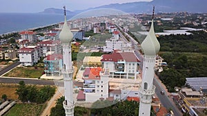 Beautiful view of the city. Clip. A mosque with domes next to houses and in the background the sea and mountains and