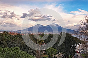 Beautiful view of the city of Napoli Naples and mountain Vesuvius in the background at cloudy winter day. Campania, Italy