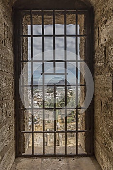 Beautiful view of the city and the PeÃÂ±a de los Enamorados or The Lovers` Rock through a window with metal grating photo