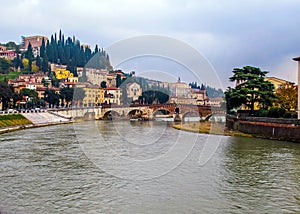 Beautiful view of the cityscape of Verona, river Adige and historic stone bridge Ponte Pietra. Italy