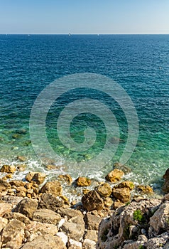 Beautiful view of the cliff submerging under the crystal clear waters of the Mediterranean Sea.