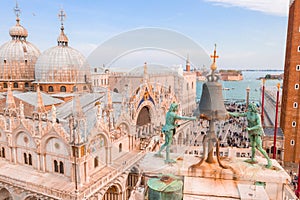 Beautiful view of the clocktower decorated with a large bell and two fauns on the tower