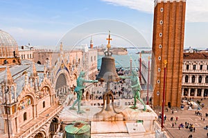 Beautiful view of the clocktower decorated with a large bell and two fauns on the tower