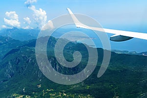 beautiful view of the coast of Montenegro from the height of an airplane flight, mountains and sea, blue sky with soft clouds and