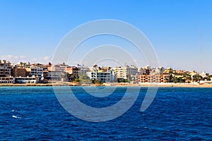 Beautiful view of coastline with houses and hotels in Hurghada, Egypt. View from Red sea