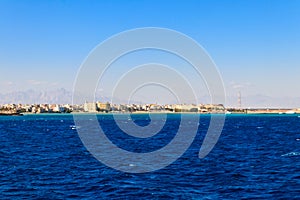 Beautiful view of the coastline with houses and hotels in Hurghada, Egypt. View from Red sea