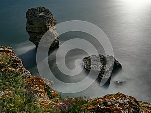 Beautiful view of the coastline with rocks in the water, long exposure