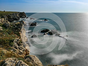 Beautiful view of the coastline with rocks in the water, long exposure