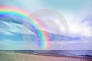 Beautiful view of colorful rainbow in sky over sea