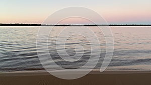 Beautiful view of a colorful sunset over the sea and white sandy beach in Argentina