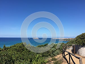 Beautiful view of the crystal clear sea of the coast of Sardinia near the red island