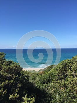 Beautiful view of the crystal clear sea of the coast of Sardinia near the red island