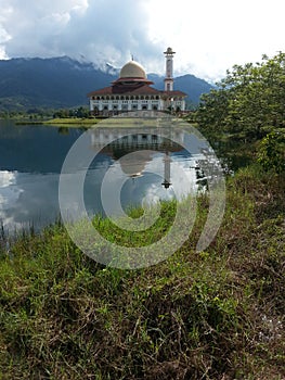 Beautiful view of Darul Quran Mosque with reflections during sunrise