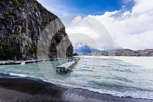 Beautiful view of deck during low tide in Glacier Gray, with mountain range with snow in the background. Torres del Paine, Chile