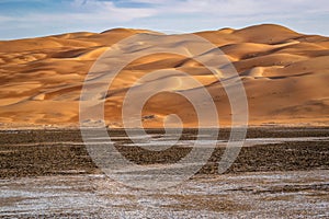 A beautiful view of a desert Vally with nice and clean sand dunes an blue sky,