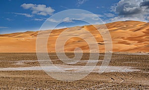 A beautiful view of a desert Vally with nice and clean sand dunes an blue sky,