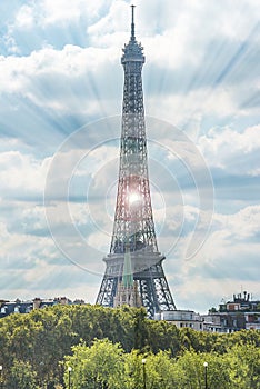 Beautiful view of Eiffel Tower against the white clouds on the blue sky on sunny summer day