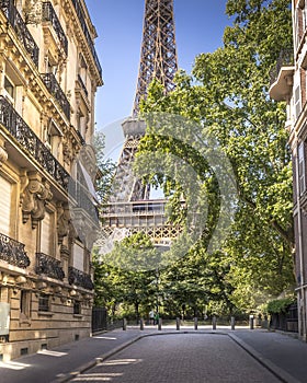 Beautiful view of Eiffel Tower from a street with Haussmann buildings