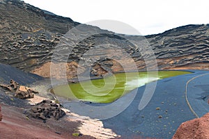 Beautiful view of El Lago Verde. Green lagoon with black sand beach. Lanzarote, El Golfo, Canary Island, Spain, Europe