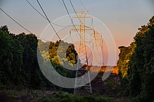 Beautiful view of electrical tower silhouette at country sunset