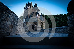 Beautiful view of Eltz Castle surrounded by trees in the evening