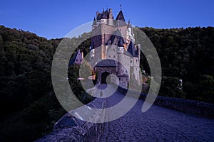 Beautiful view of Eltz Castle surrounded by trees in the evening