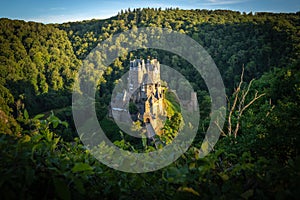 Beautiful view of Eltz Castle surrounded by trees on a sunny day