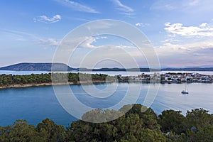 Beautiful view of Ermioni sea lagoon with moored yachts and boats at sunset time