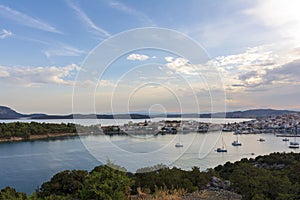 Beautiful view of Ermioni sea lagoon with moored yachts and boats at sunset time