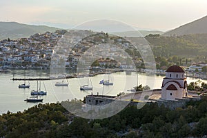 Beautiful view of Ermioni sea lagoon with moored yachts and boats at sunset time