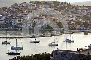 Beautiful view of Ermioni sea lagoon with moored yachts and boats at sunset time