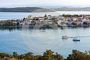 Beautiful view of Ermioni sea lagoon with moored yachts and boats at sunset time