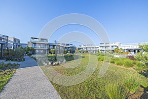 Beautiful view of exterior of Portes Lithos Luxury Resort hotel buildings.