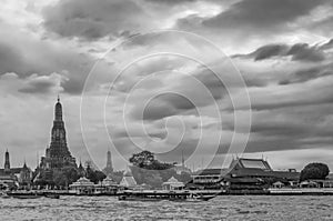 Beautiful view of the famous Buddhist Temple of Dawn, Wat Arun, on the Chao Phraya River, against a dramatic sky Bangkok, Thailand