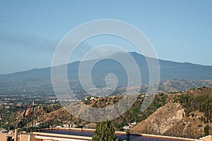 Hotel Elios overlooking scenic view of Etna Volcano with blue sky in background photo
