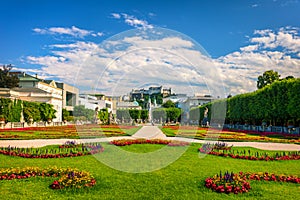 Beautiful view of famous Mirabell Gardens with the old historic Fortress Hohensalzburg in the background in Salzburg, Austria.