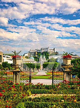 Beautiful view of famous Mirabell Gardens with the old historic Fortress Hohensalzburg in the background in Salzburg, Austria.