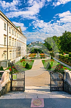 Beautiful view of famous Mirabell Gardens with the old historic Fortress Hohensalzburg in the background in Salzburg, Austria.