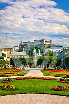 Beautiful view of famous Mirabell Gardens with the old historic Fortress Hohensalzburg in the background in Salzburg, Austria.