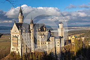 Beautiful view of the famous Neuschwanstein Castle at sunset in winter, with beautiful sunshine and the Forggensee lake in