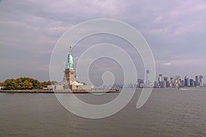 Beautiful view of famous Statue of Liberty and Manhattan on background.