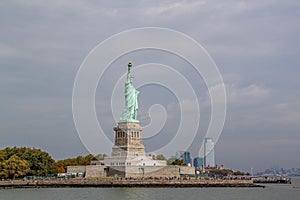 Beautiful view of famous Statue of Liberty and Manhattan on background.  Liberty Island in New York Harbor in New York