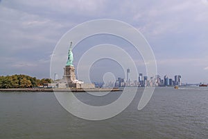 Beautiful view of famous Statue of Liberty and Manhattan on background.  Liberty Island in New York Harbor in New York