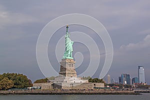 Beautiful view of famous Statue of Liberty and Manhattan on background.  Liberty Island in New York Harbor in New York.