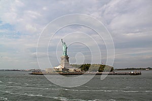 Beautiful view of famous Statue of Liberty and Manhattan on background. Liberty Island in New York Harbor in New York