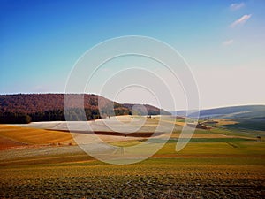 Beautiful view of the field and a mountain range of the mountains in Germany