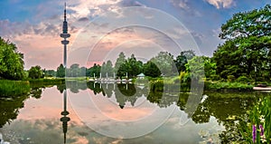 Beautiful view of flower garden in Planten um Blomen park with famous Heinrich-Hertz-Turm tower at dusk, Hamburg, Germany photo