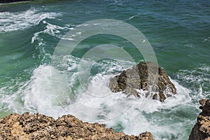 Beautiful view of foamy waves between big rocks. Natural backgrounds concept.