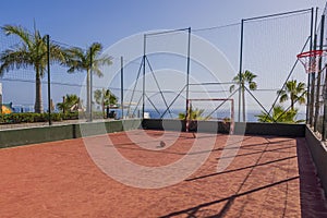 Beautiful view of football mini court on blue sky merging with blue ocean background. Spain.