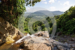 Beautiful view of a forest and mountains from the top of a waterfall